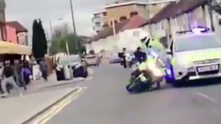 Policeman pushed from motorcycle in London